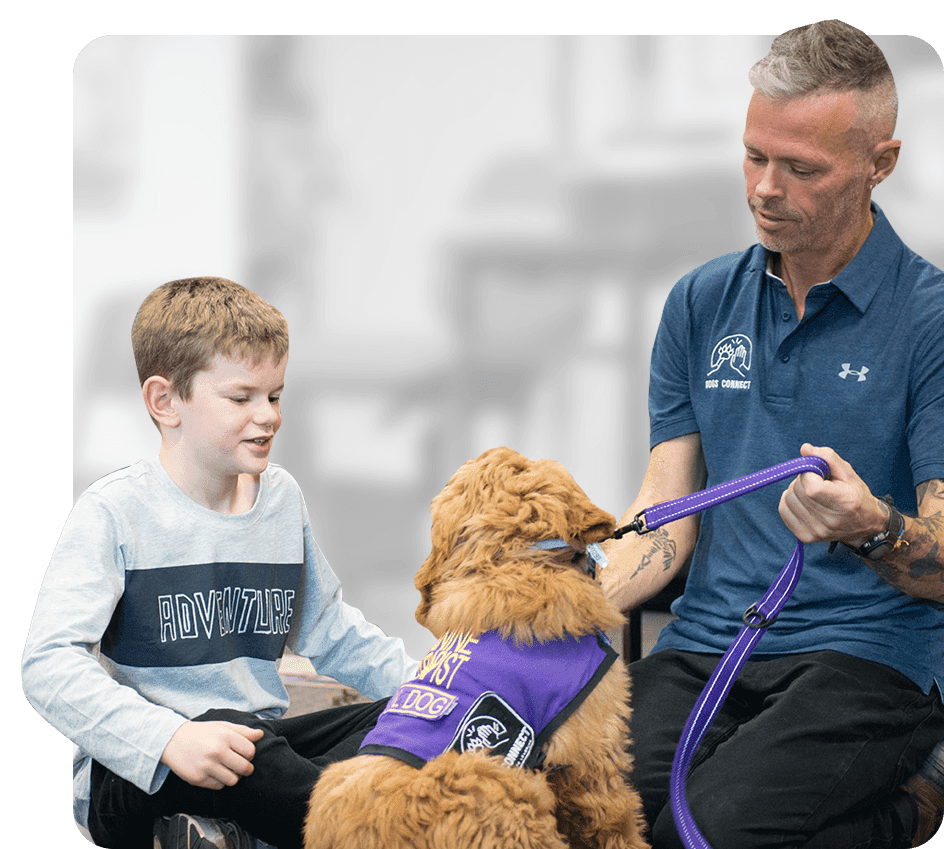 Grant Shannon and a student with a wellbeing dog in a working vest